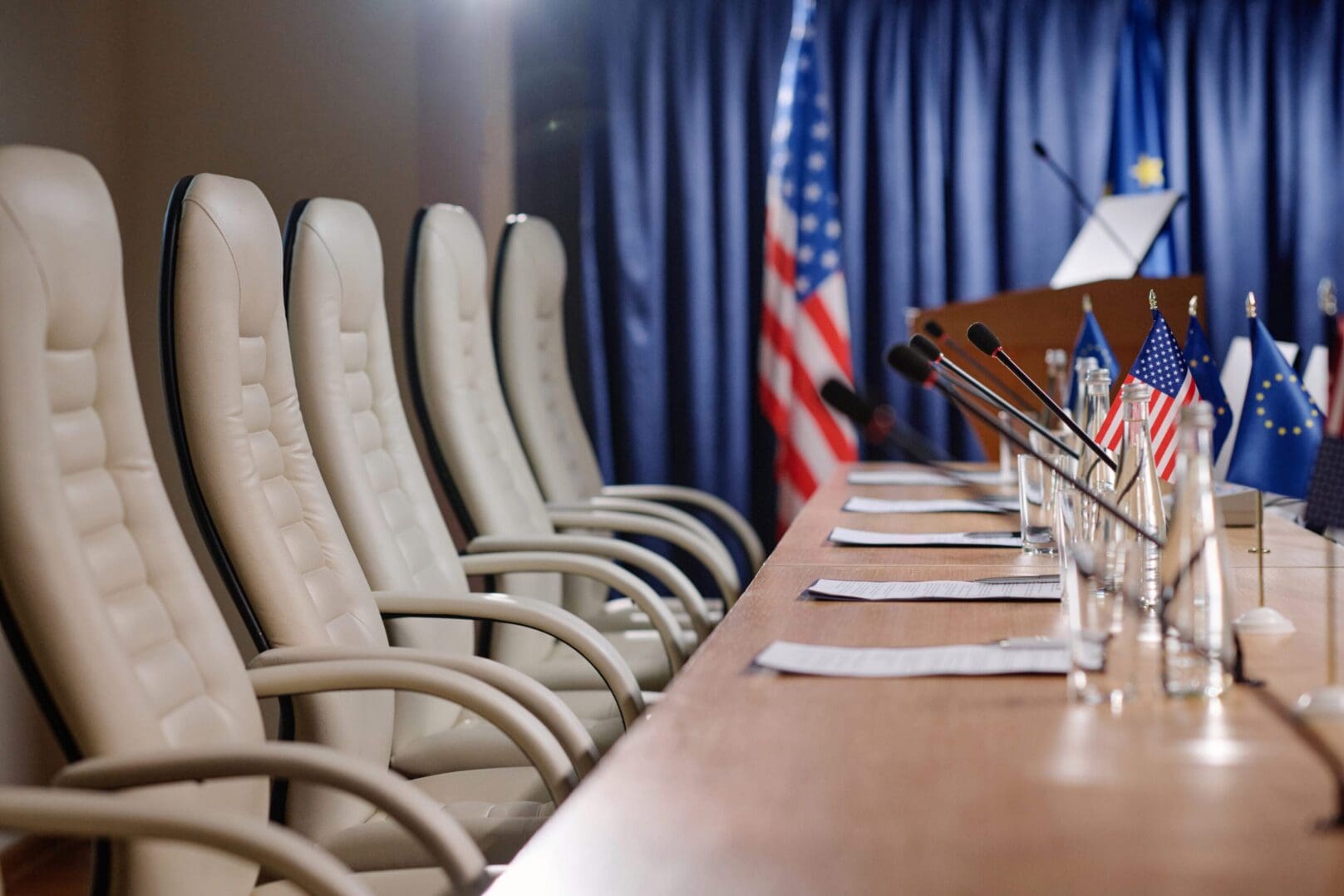 A row of chairs in front of a table.